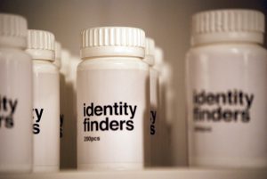 A photograph of several pill bottles, bearing the legend "Identity finders".