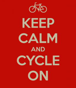 White text on red background that reads "KEEP CALM AND CYCLE ON". An image of a white bicycle is at the top of the text.