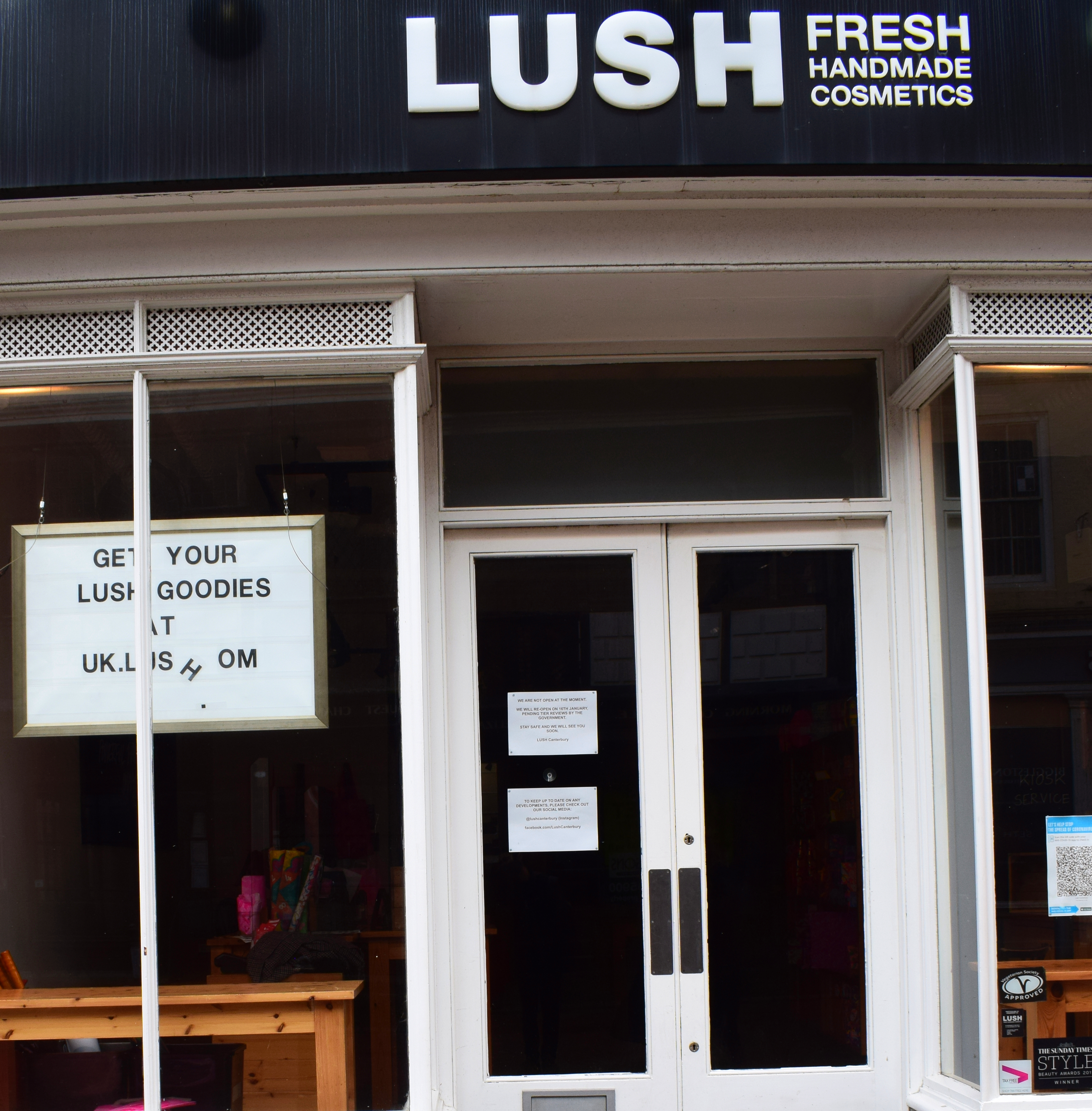 Picture B: The storefront of Lush Canterbury, with the letters on the sign falling off and the shop entirely empty. 