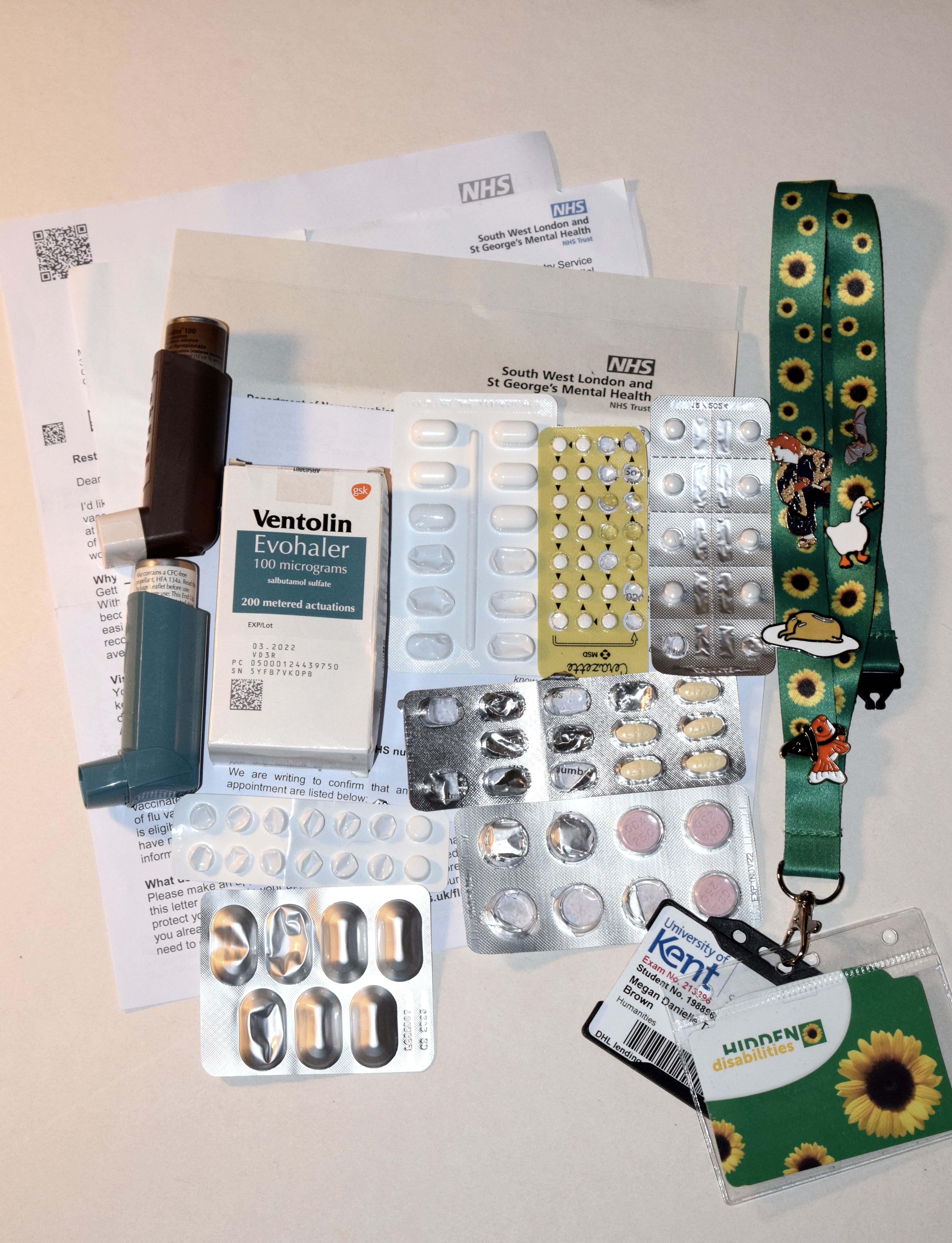 Picture shows a wide selection of medication and several medical letters, demonstrating the poor health of the subject.