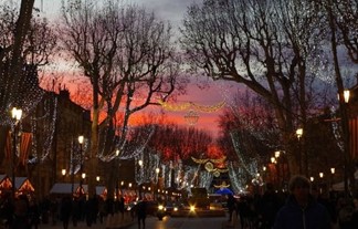 A street lit up with Christmas lights