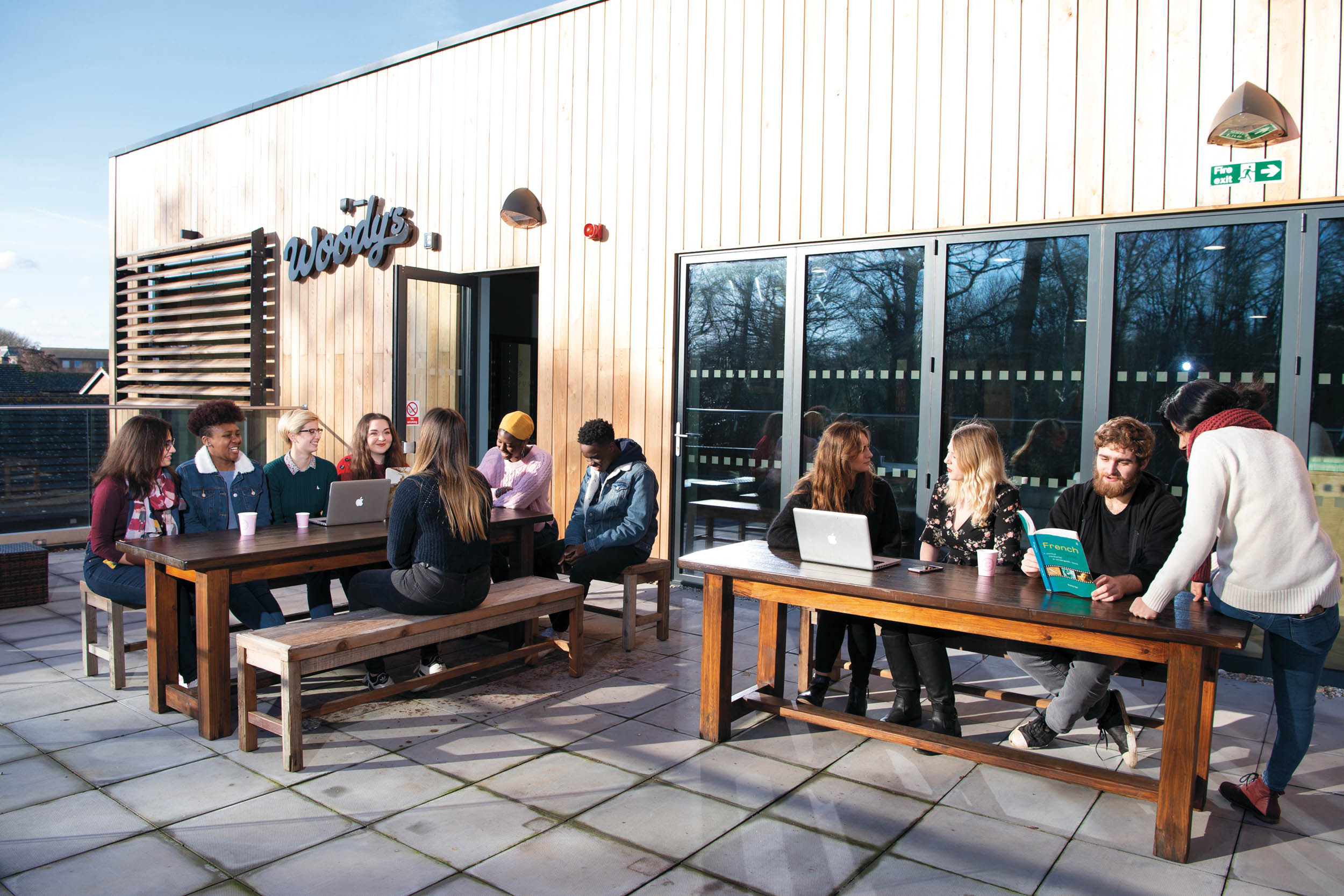 Students sitting on Woody's terrace