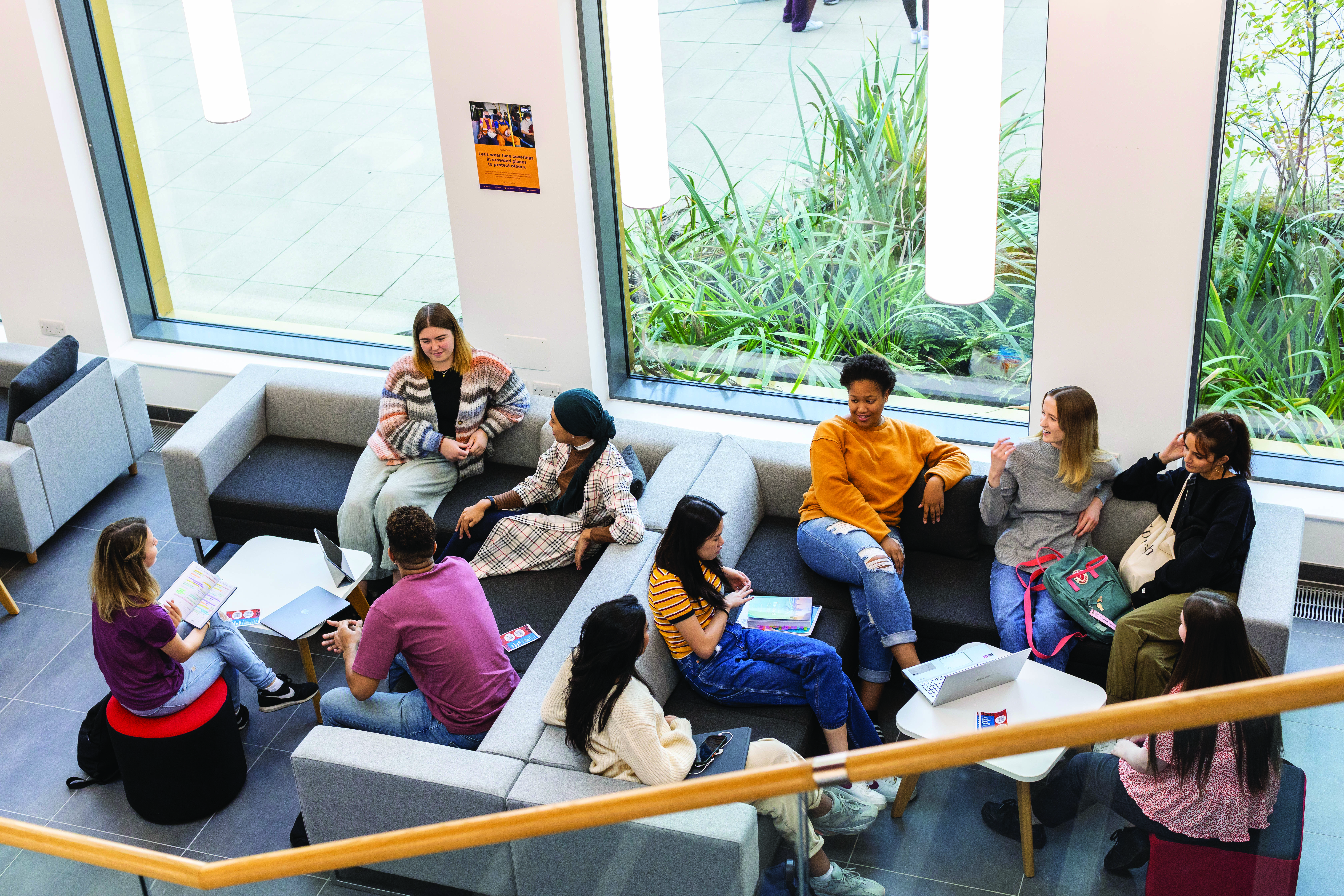 Two groups of students sit on the sofas in a common area at University of Kent. 