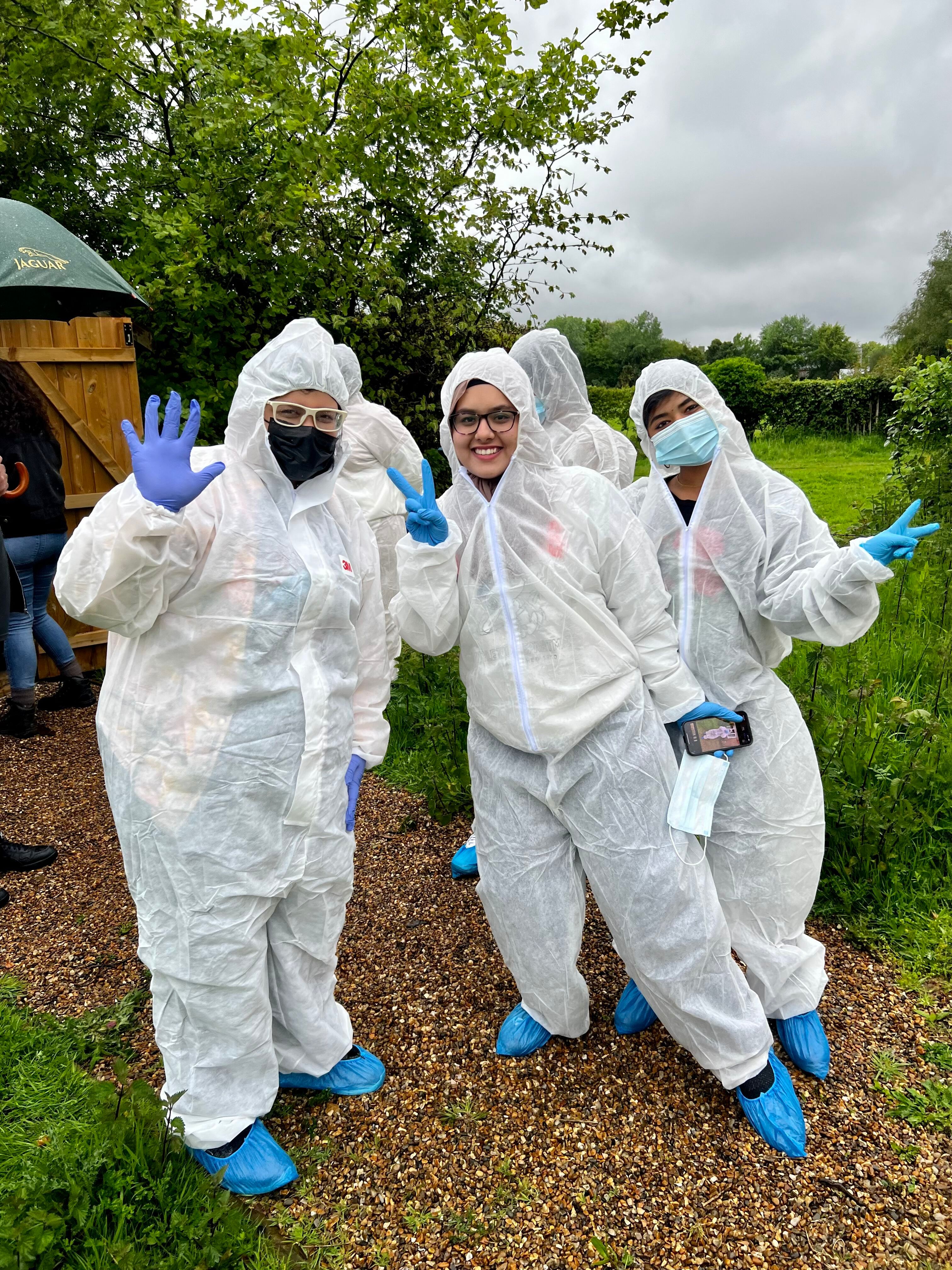 Amity students pose in their biohazard suits in the crime scene facility garden