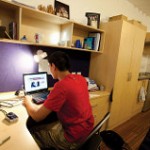 An image of a student in a student bedroom