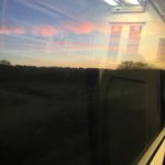 An image of a sunrise from a train