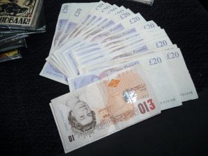 £10 and £20 notes fanned out on a table