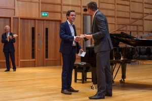 Matthew Bamford receives his award from Dan Lloyd