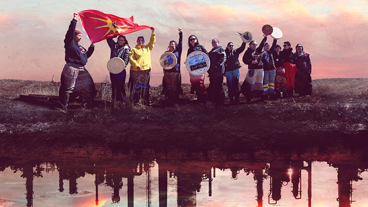 Image from There's Something In The Water poster featuring a band of indigenous environmental racism activists on a wasteland with the reflection of industrial polluters below them in the water.