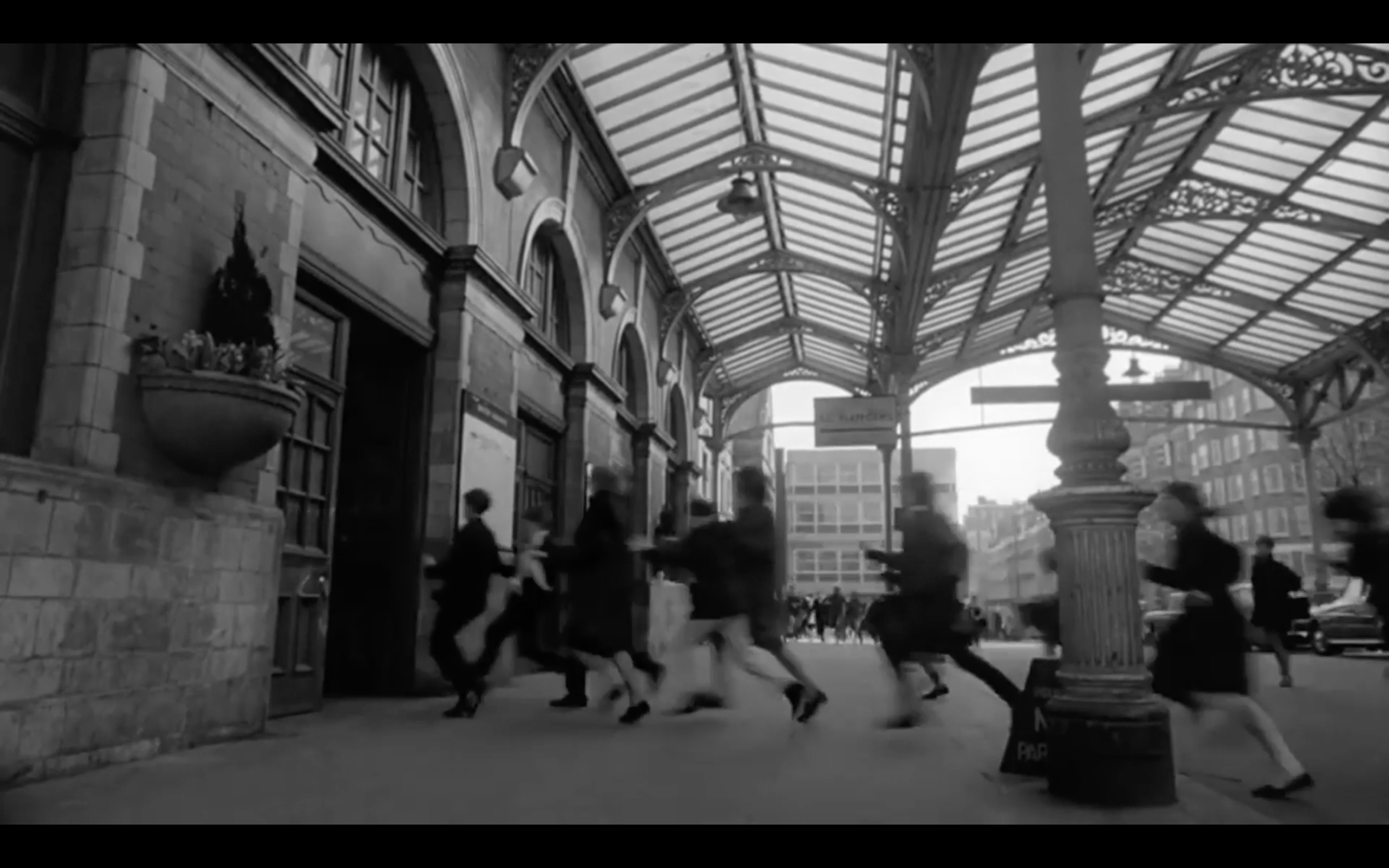 Archive footage of girls running for a train to get to a Beatles gig. 