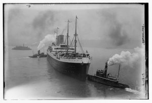 A picture of the ship SS Deutschland and two tugboats with smoke and steam emerging from their funnels.