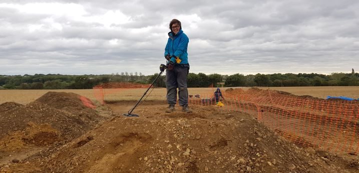 An academic with a metal detector on the Blean Church Field Dig