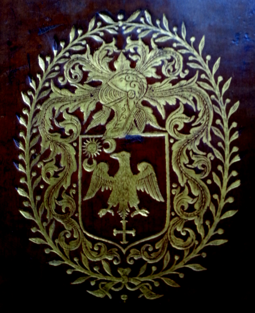 Gold tooled coat of arms on the front cover of 'Sancti Bonaventurae ex Ordine Minorum S.R.E. Episcopi Card. Albanen. eximii Eccles. doctoris Opera'