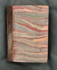 Front cover of book recovered in marble paper. The measurements of the book are 191(l)x138(w)x127(d)mm which indicates that it would have been an easily portable book.