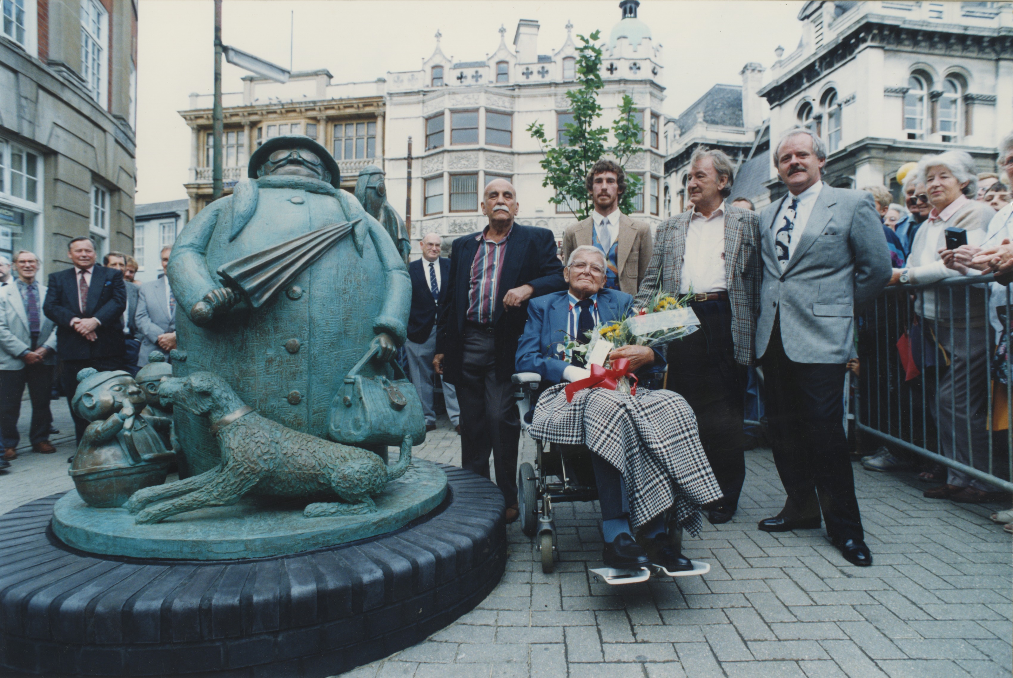 Colour photo of the unveiling of the Grandma statue in Ipswich, featuring actor Warren Mitchell , Giles, the sculptor Miles Robinson, writer and friend Johnny Speight, and Andrew Cameron (Express Newspapers) - September 1993 (Image ref: GAPH00430)