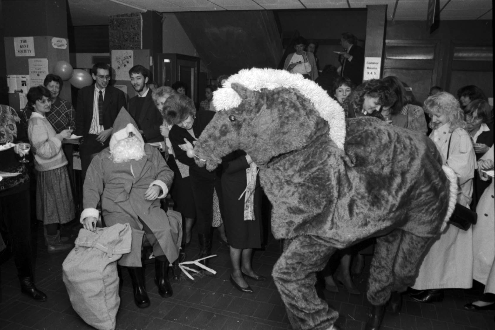 Black and white photograph showing a party in the Registry Office, 1990, complete with Santa and a pantomime horse. [University of Kent Archive, 1471.2]
