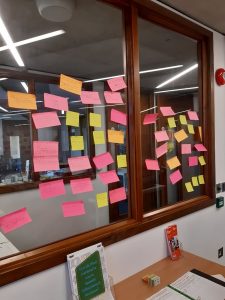 Coloured post-it notes on window in Special Collections reading room from War of the Roses: text and adaptation seminar