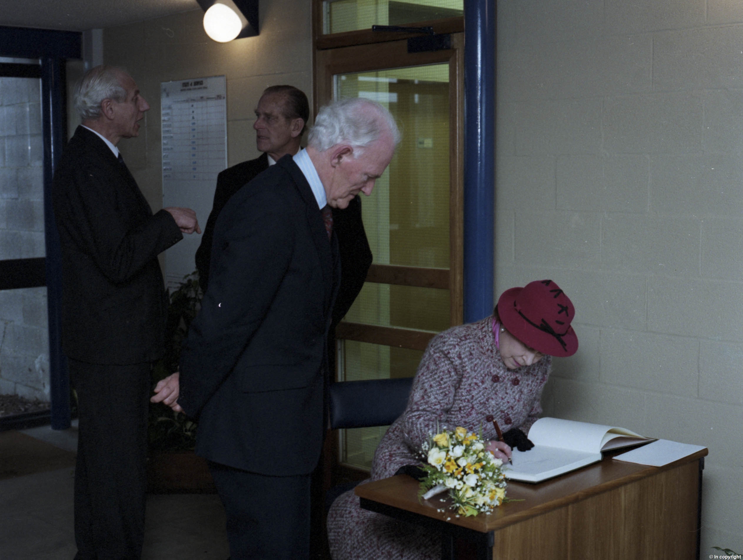 Queen signing the University visitor book when she and Philip came to open the Cornwallis extension (the Octagon)