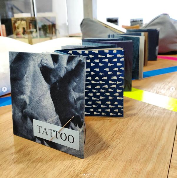Image showing the concertina length of Tattoo, with needle inserted into front cover.
