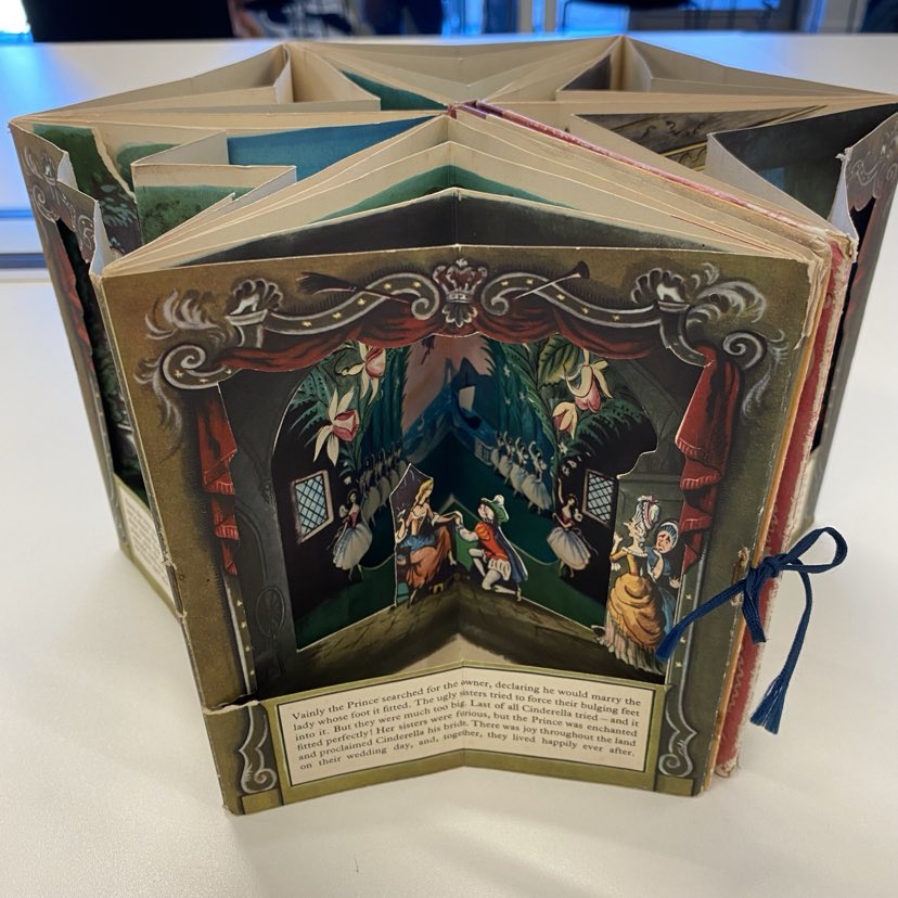 Picture of Roland Pym's Cinderella, a peepshow book open to display the finale scene where Cinderella reclaims her glass slipper.