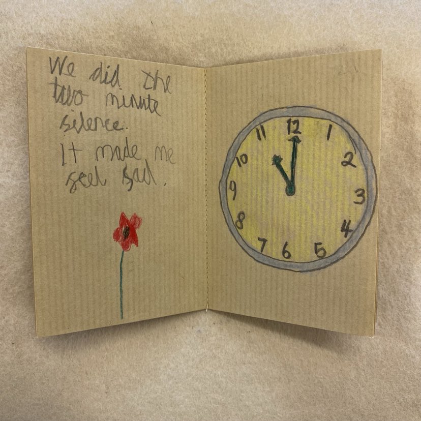 Picture of Ben Thurston's untitled diary, open at a page which features a drawing of a clock showing the time of 11am, with a descriptive sentence stating 'we did the two minute silence. It made me feel sad.'