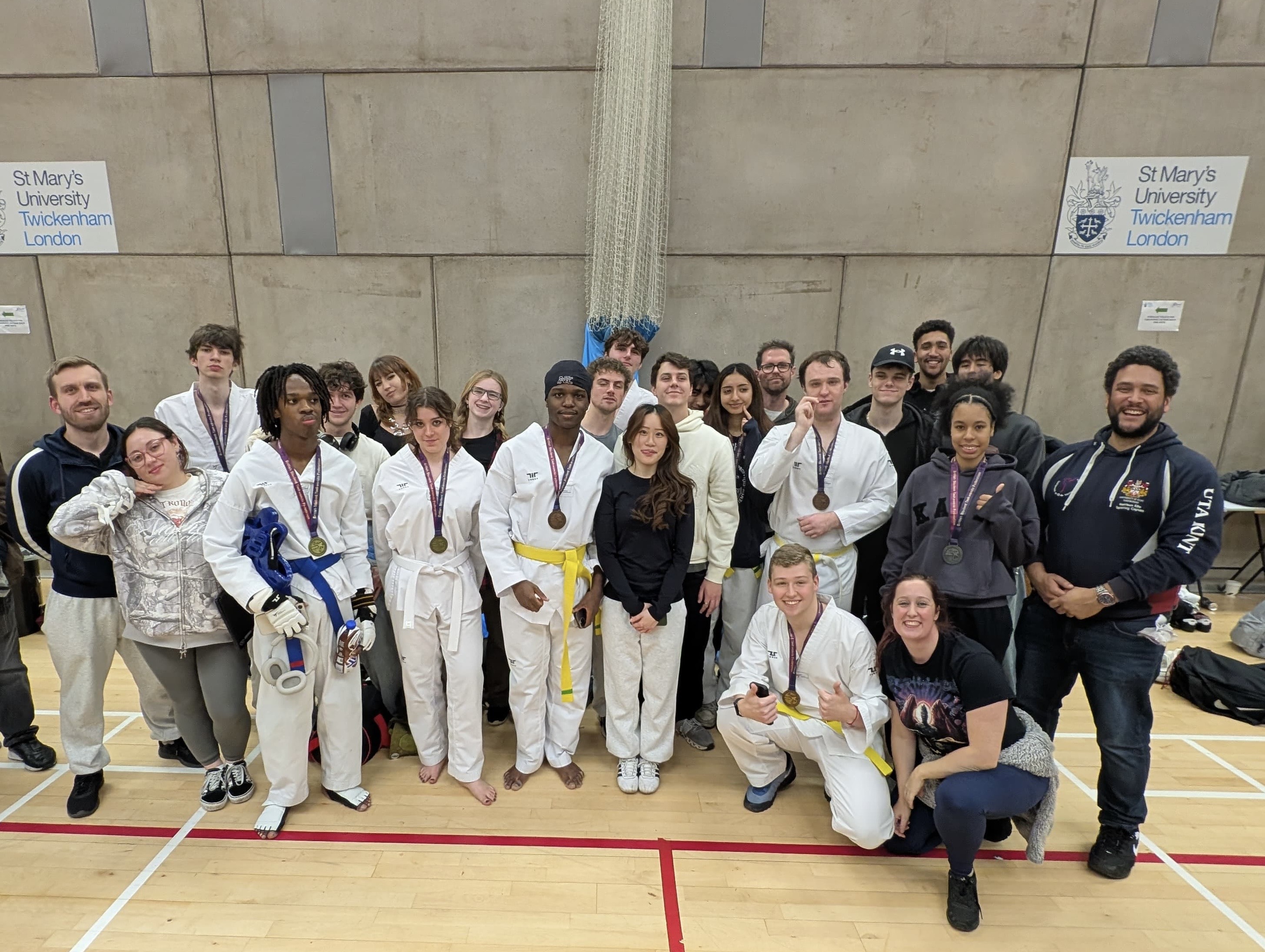 Taekwondo Society group photos with their medals after national competition.