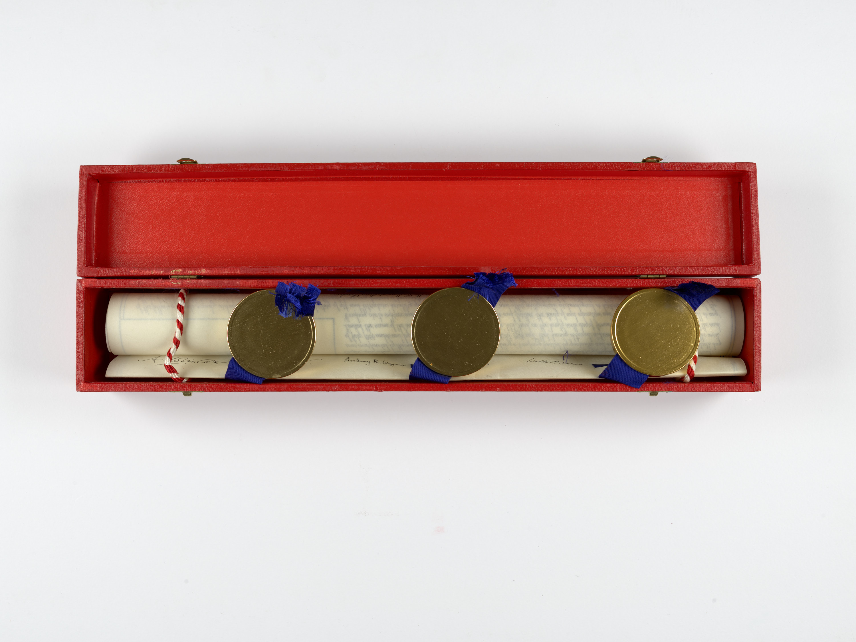 Rolled document - a coat of arms - in a red box with gold wax seals and blur ribbons