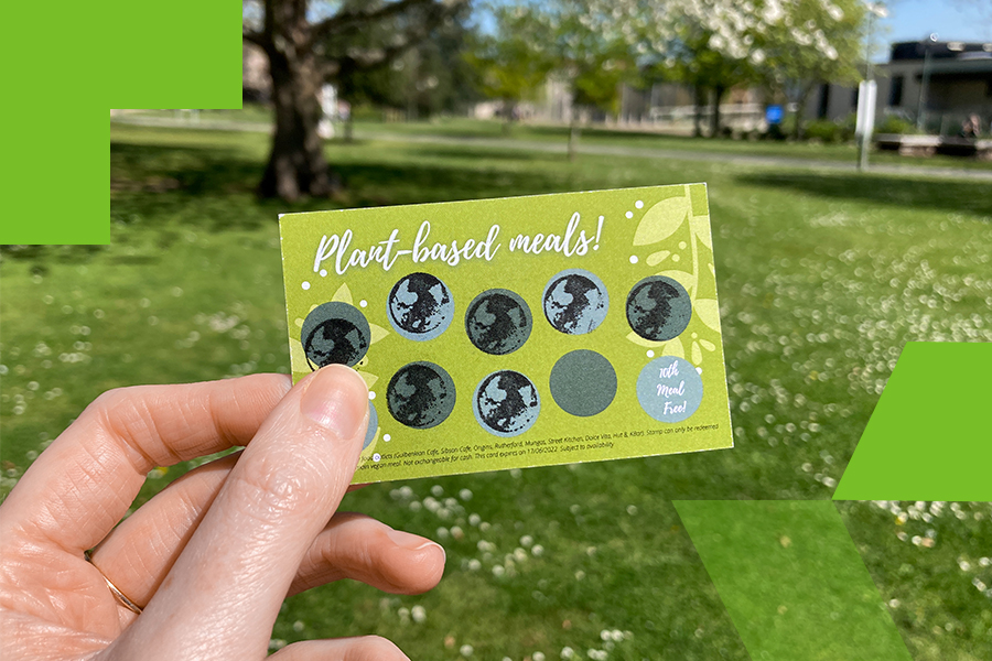 A close up image of a hand holding the plant-based loyalty card which has been stamped a number of times 