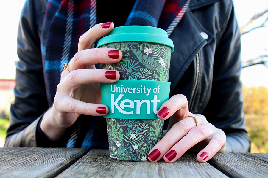 Hands holding a Kent branded reusable coffee cup