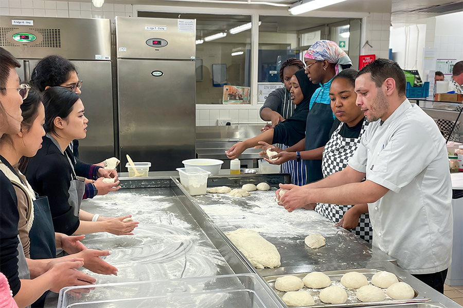 Darwin chef, Nick Constantinou, shows students how to make a classic pizza dough.