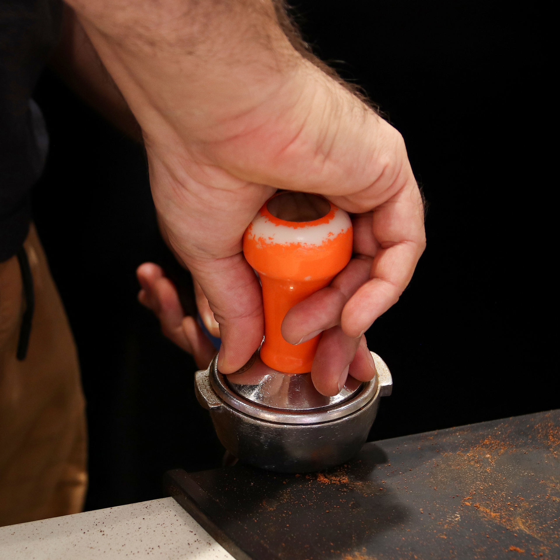 Tamping coffee grounds