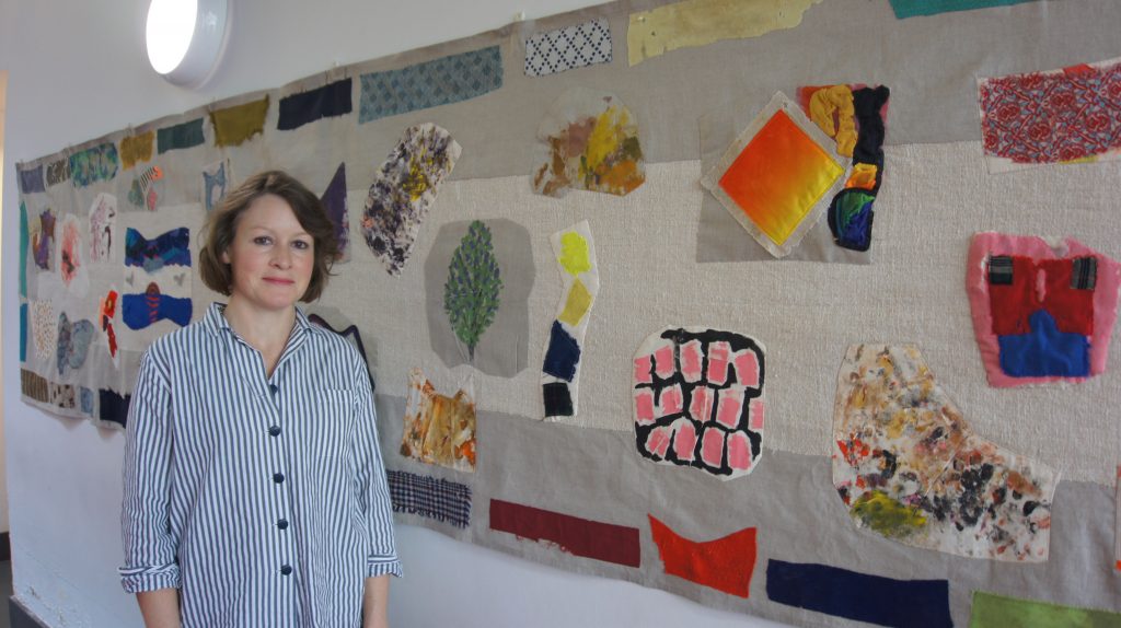 Artist Joy C Martindale in front her collaborative work 'Lilacs in Bloom'