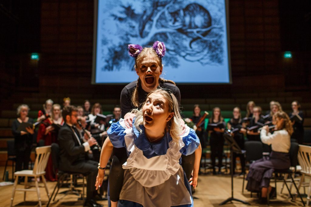 Sophia Lyons as Alice and Maddie Jones as the Cheshire Cat