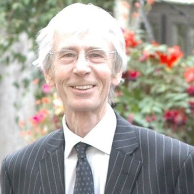 A portrait photograph of Steve Neale wearing a grey suit.