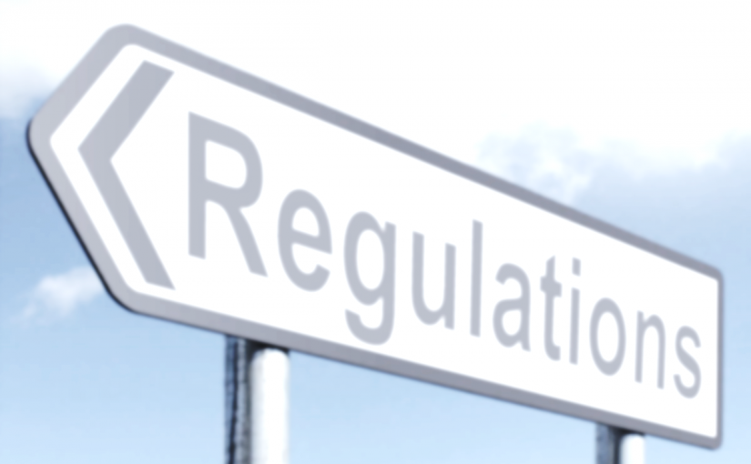 Photograph of a roadsign pointing to the left, that reads "Regulations".