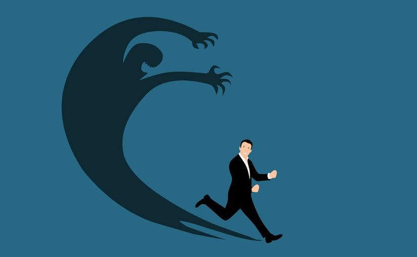 A man in a business suit runs away from his own shadow, which is curving up over his head with outstretched arms in a threatening gesture.