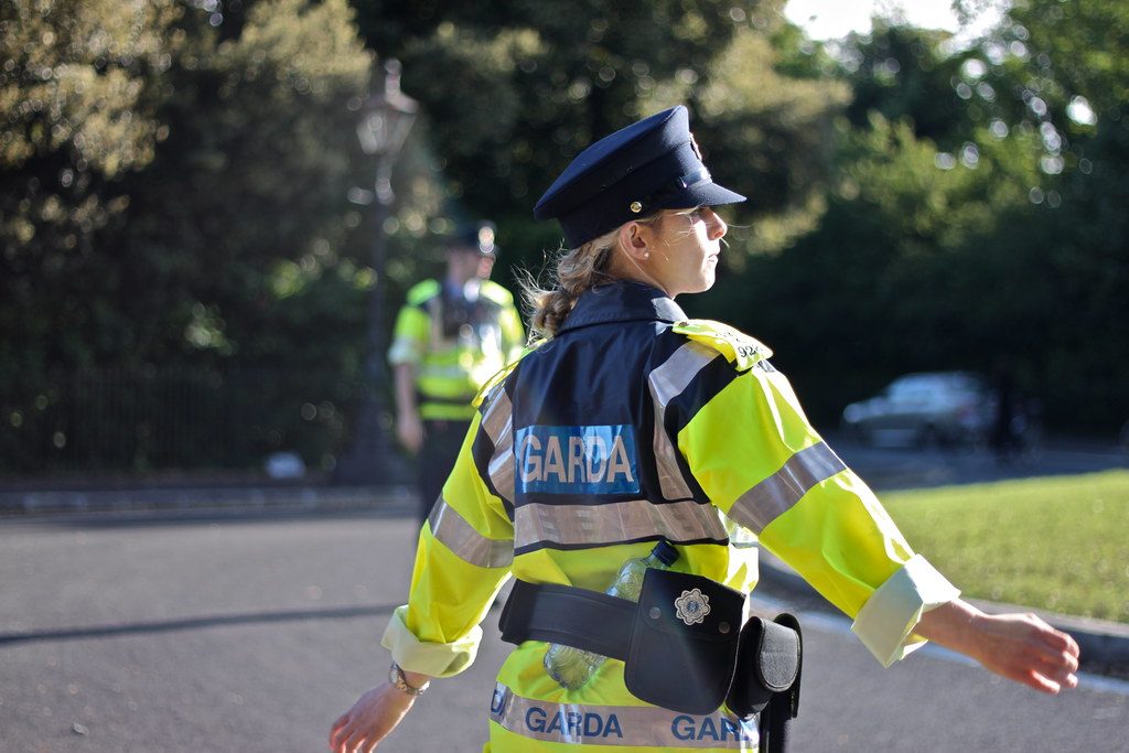 Female Garda police officer with her arms outstretched