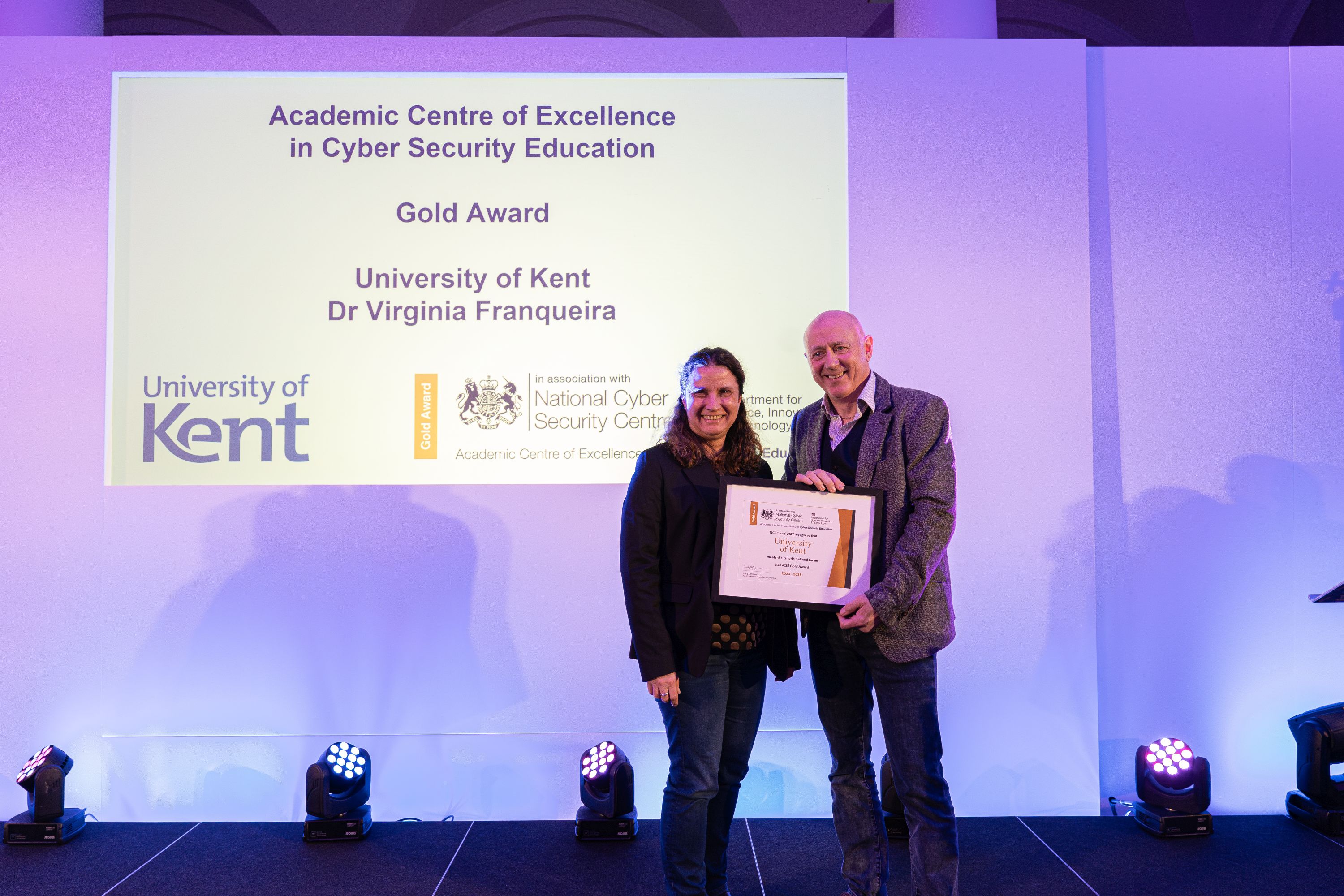 Dr Virginia Franqueira receiving University of Kent's ACE-CSE certificate from Chris Ensor