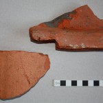 Two fragments from Roman roof tiles. The fragment on the right comes from the broad flat type (known as tegulae) which would have covered most of the roof area. This example shows traces of mortar for attachment of the arched tile type (known as imbrices) which sealed the joins between tegulae. Presumably our mortared example here had been been used for roofing at our site.