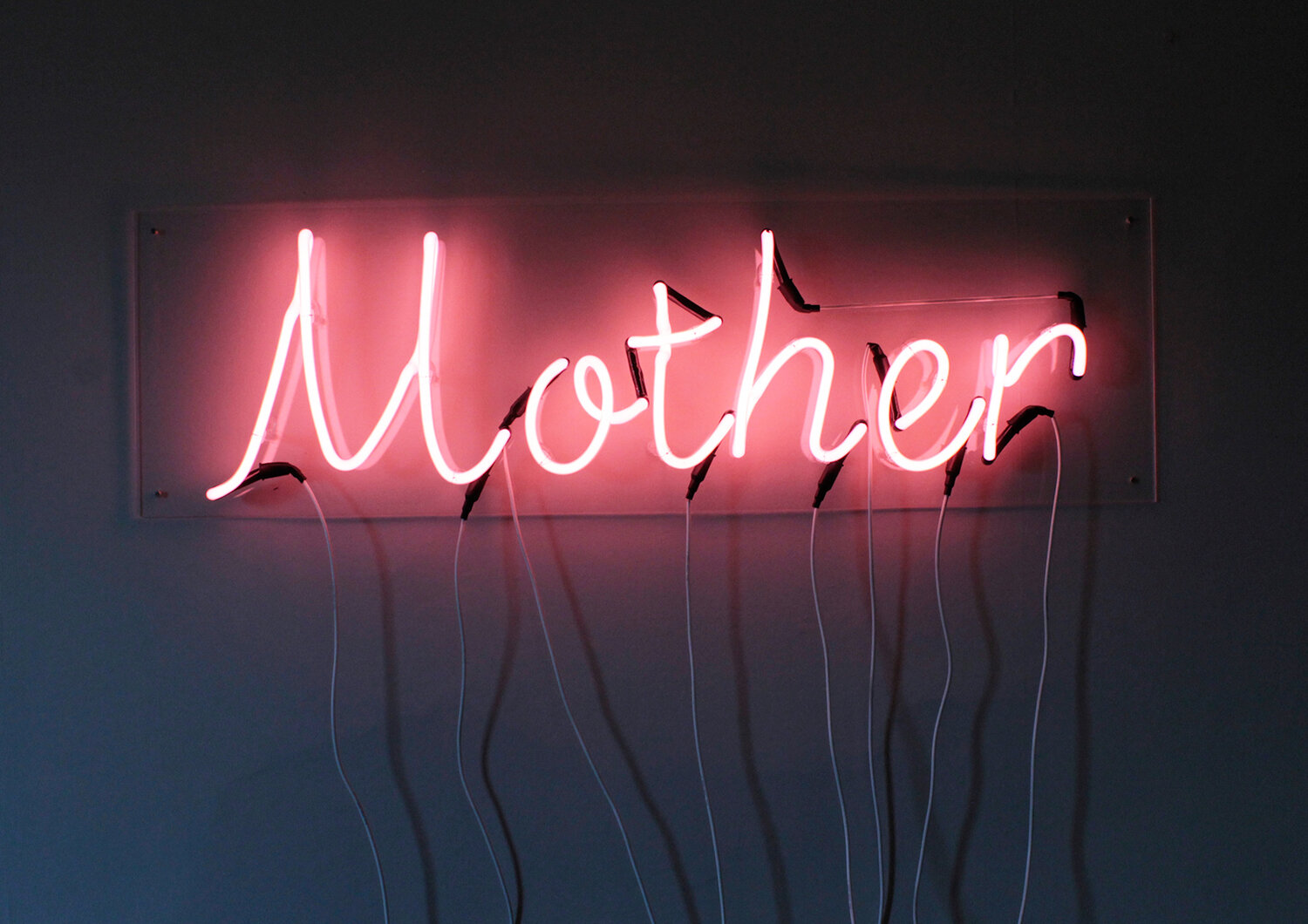 A neon sign which says Mother