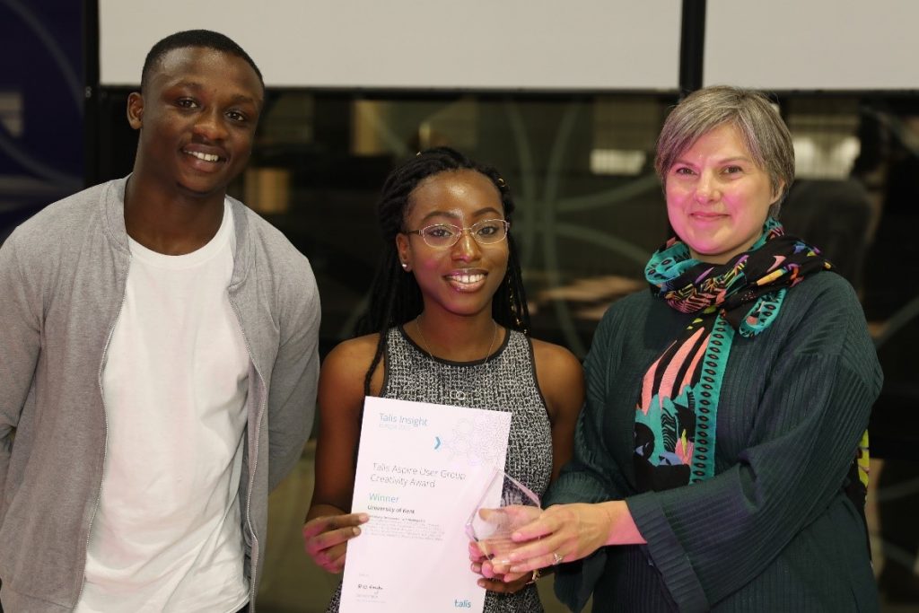 Students Collins Konadu-Mensah and Evangeline Agyeman and Liaison Librarian Sarah Field accepting the award