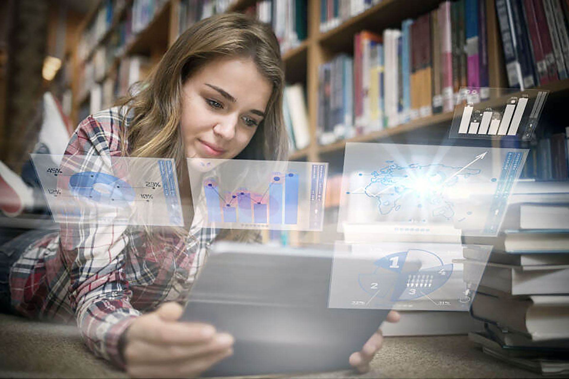 Student looking at laptop in library