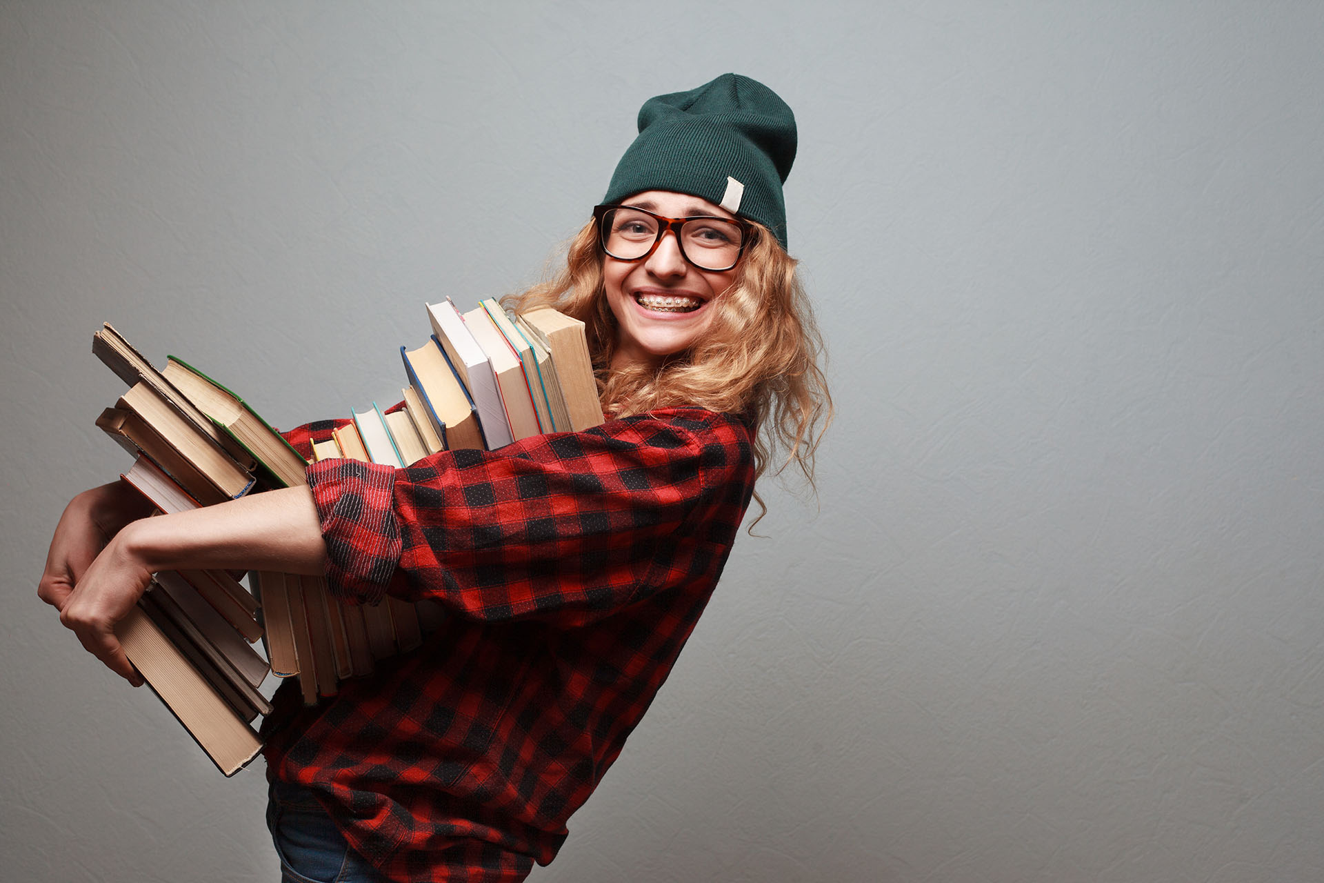 Female student holding a pile of books