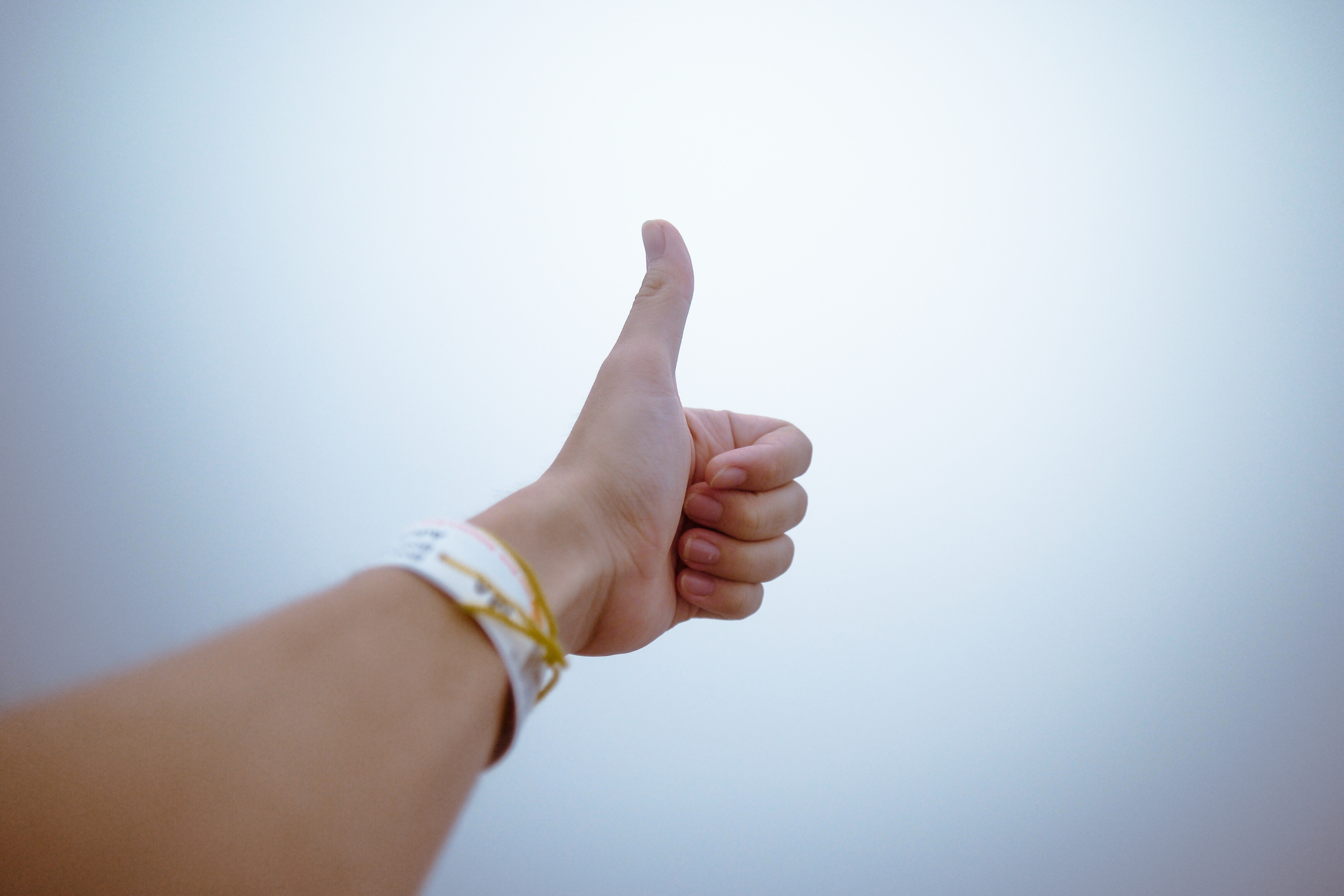 Photo of hand showing thumbs up gesture