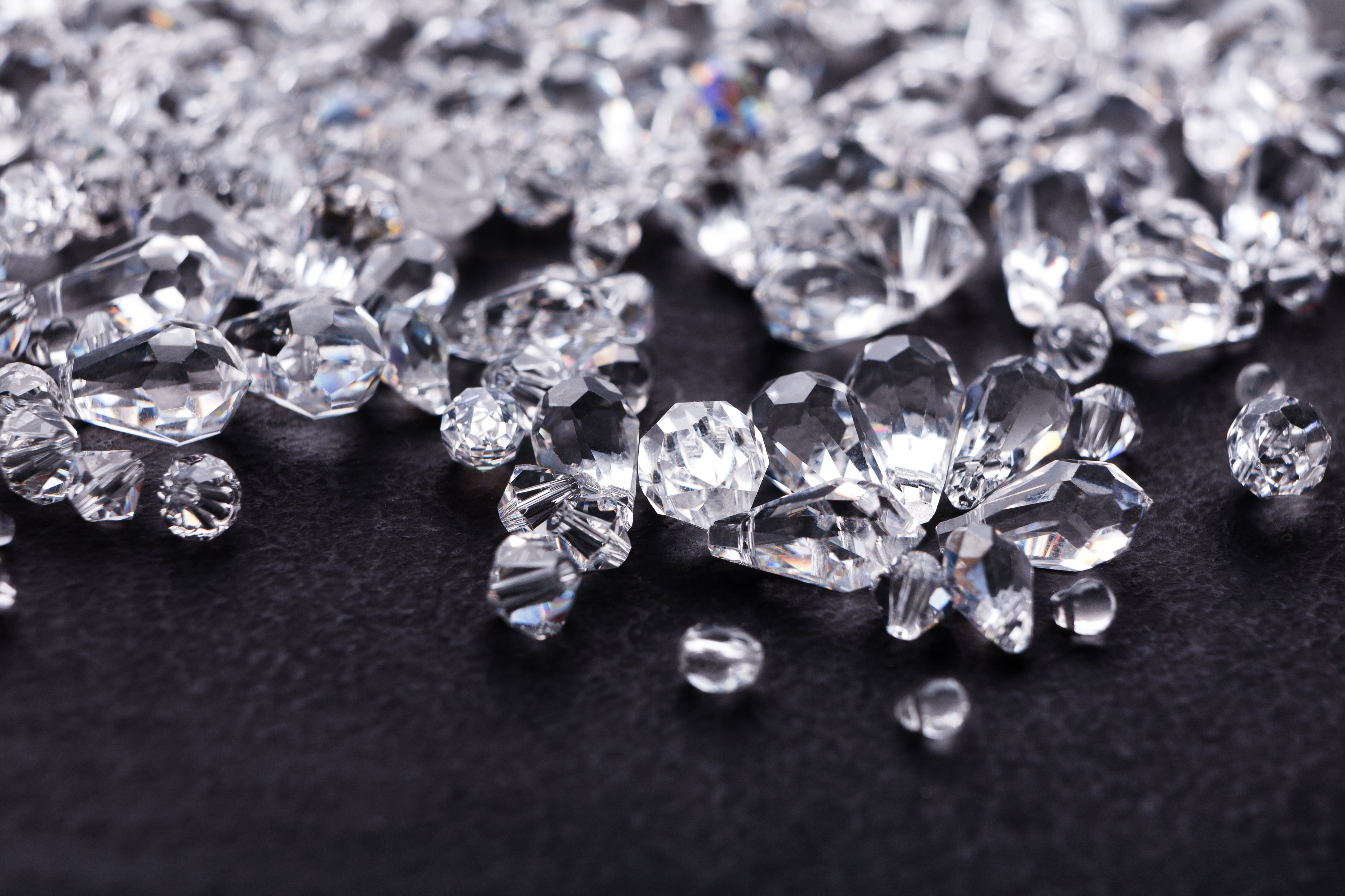 Diamonds of various sizes scatters across a dark base.
