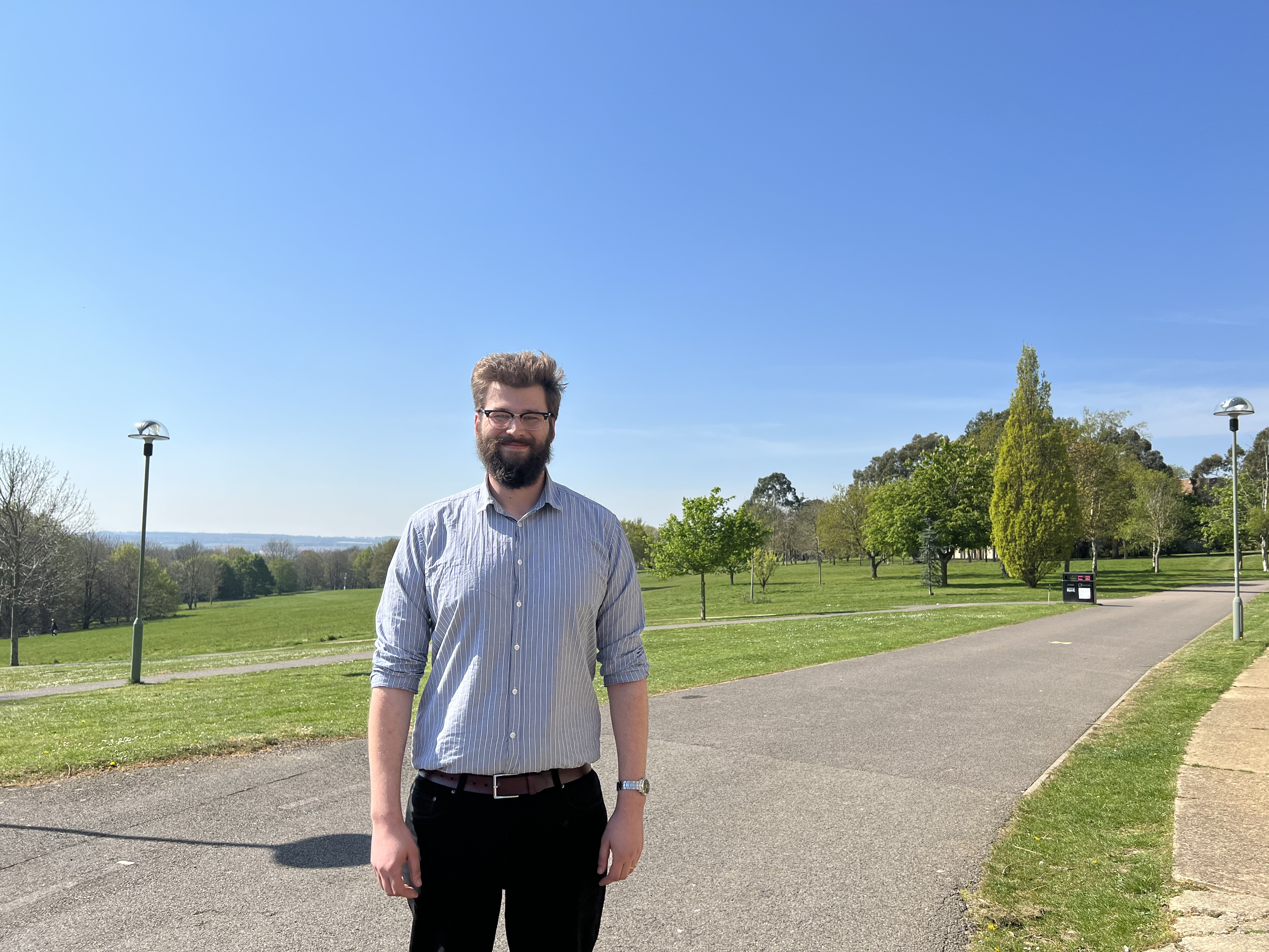Jon Drewitt outside on the Canterbury campus with grass and trees in the background