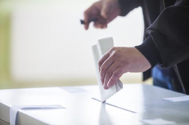Voting paper being placed in ballot box