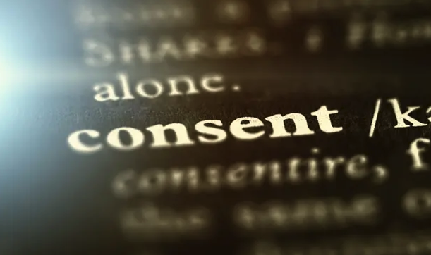 the word consent shown on black paper
