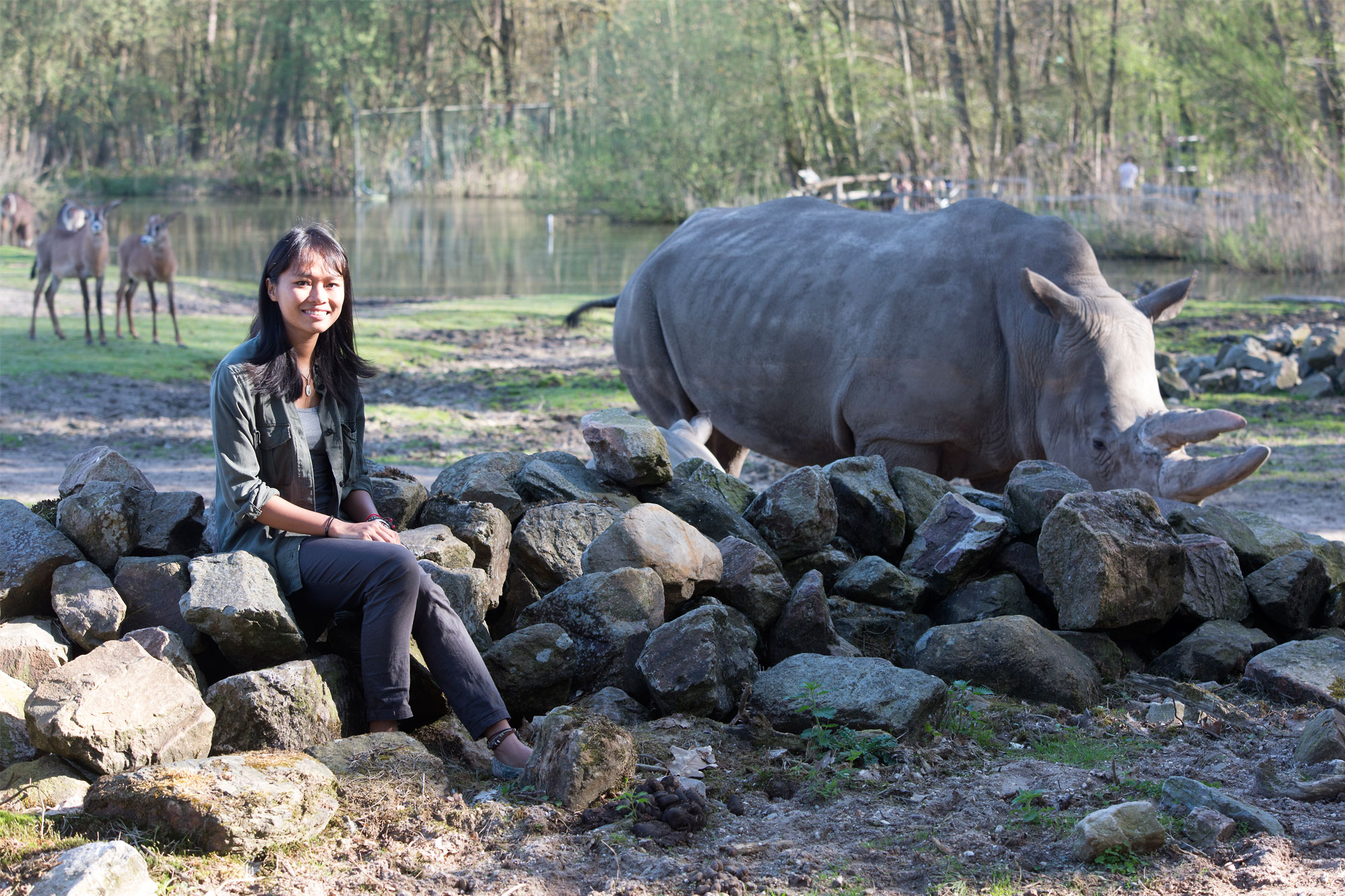 Trang Nguyen with a rhinoceros in the field