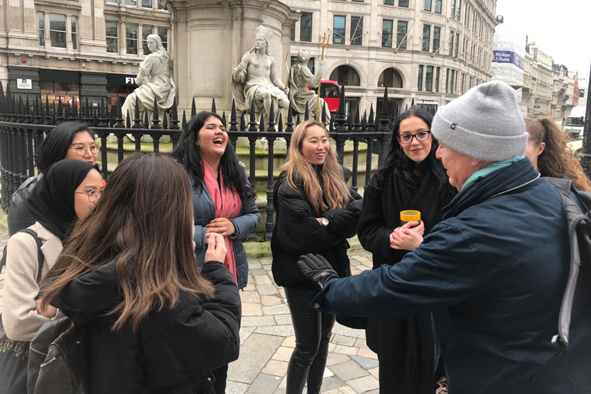 Students listen to financial expert in the streets of the City of London